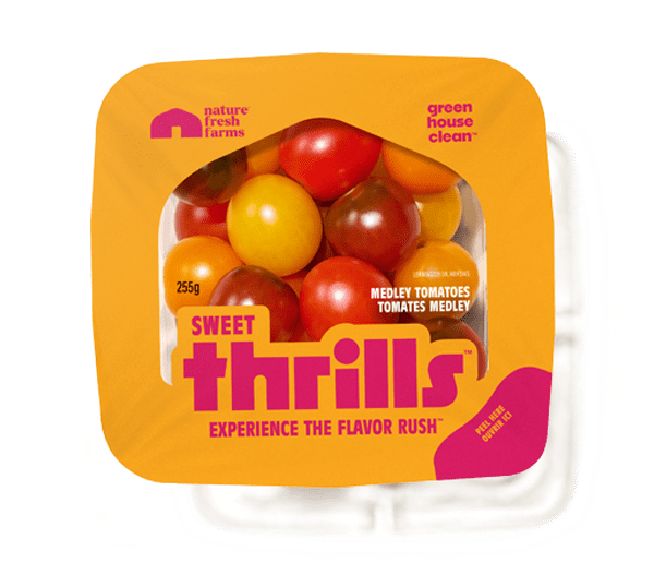A package of Nature Fresh Farms Sweet Thrills medley tomatoes in a vibrant orange and pink container.
